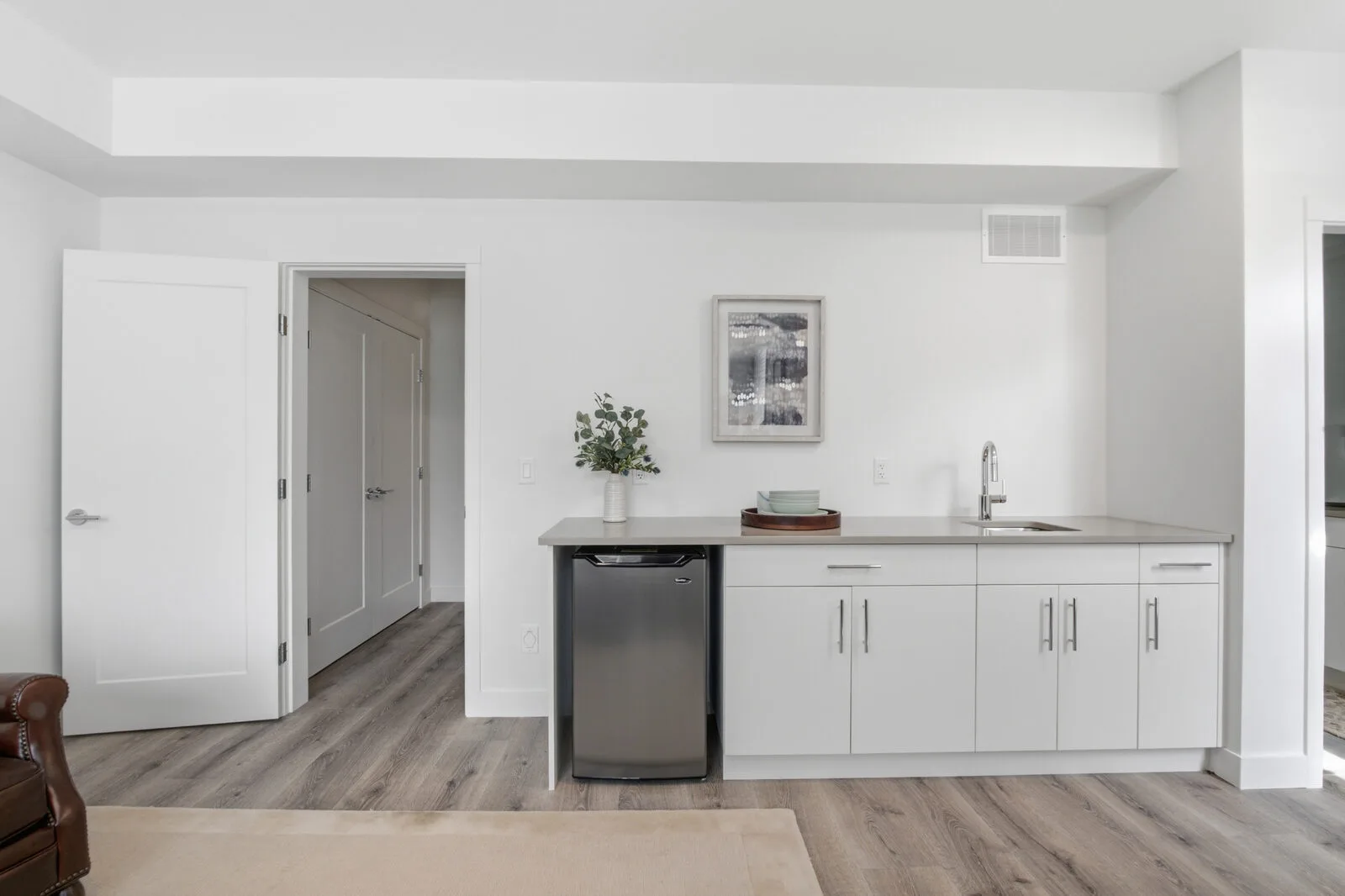 Wet bar with sink, cabinets and bar fridge in a lock-off flex room at Academy Ridge