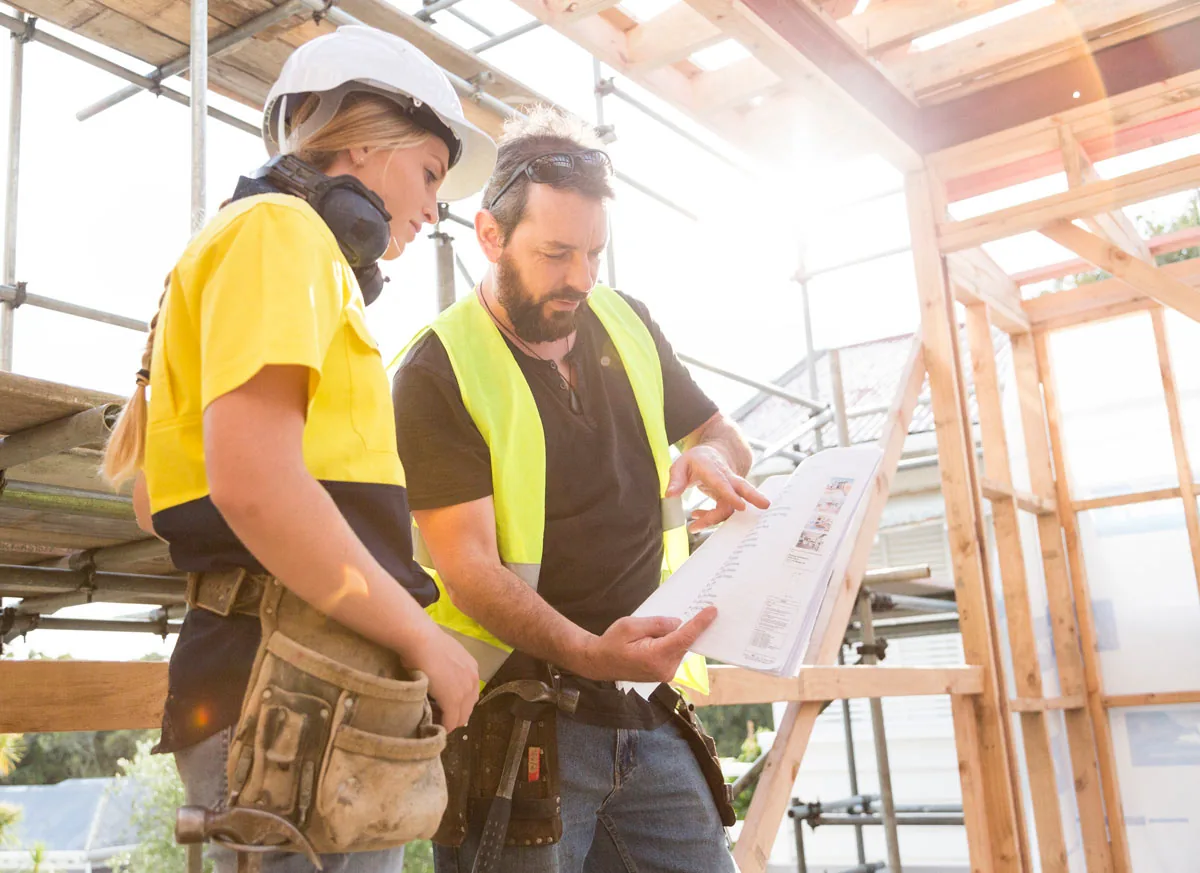Construction team reviewing plans on site