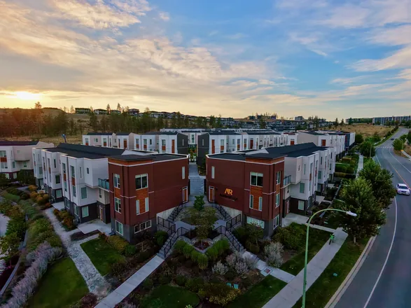 Aerial view of the Academy Ridge University Village entrance at golden hour, Academy Way in the foreground